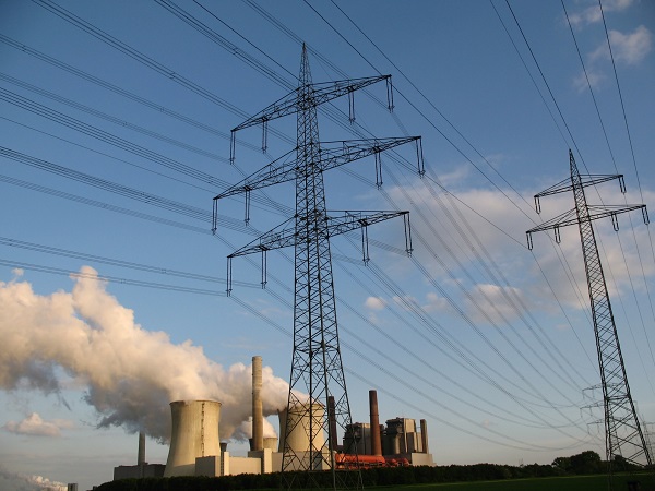 View of a coal-fired power station and electricity pylons